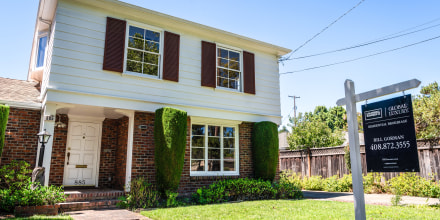 Image: A home advertised for sale in a residential neighborhood 