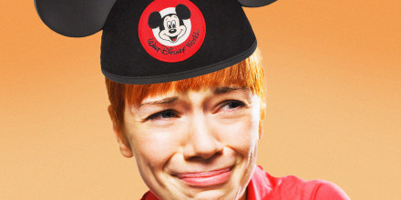 A woman wearing a Walt Disney World Mickey ears hat cries.