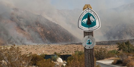 Smoke behind a sign that reads " Pacific Crest Trail"