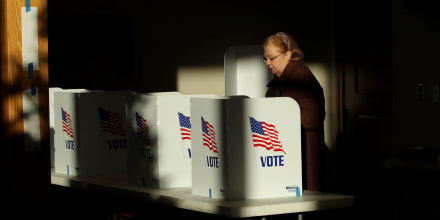 A voter casts her ballot at a polling place, in Ridgeland, Miss.