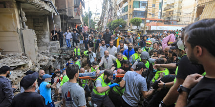 An injured man is evacuated from the scene of an Israeli strike in Beirut's southern suburbs on Sept. 20, 2024. 