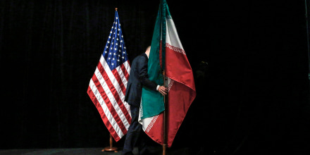 A staff removes the Iranian flag from the stage