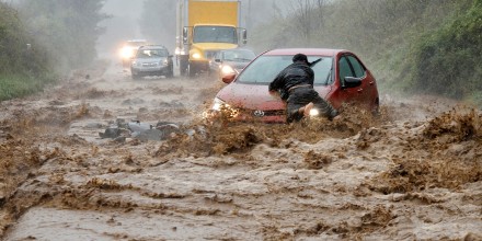 A resident helps free a stranded car as Helene strikes Boone, North Carolina