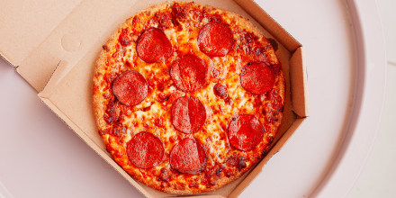 Pizza with pepperoni in box.