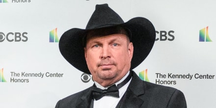 Garth Brooks stands for a photo at an event