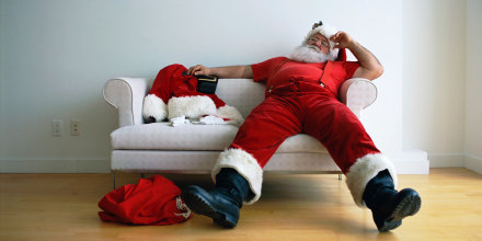 Exhausted Santa Claus on Couch