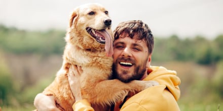 Guy and his dog, golden retriever, nature