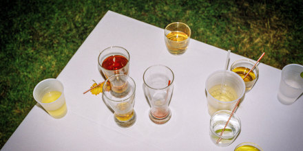 Beer and cocktail glasses on a white table.