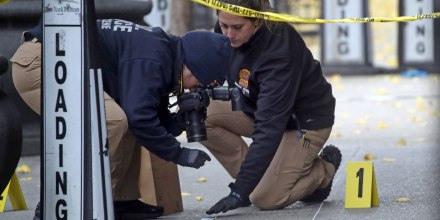 Police place bullet casing markers outside of a Hilton Hotel in Midtown Manhattan where United Healthcare CEO Brian Thompson was fatally shot on Dec. 4, 2024.