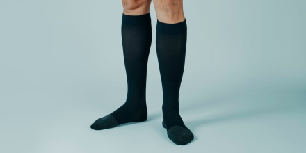 man wearing compression socks, banner format