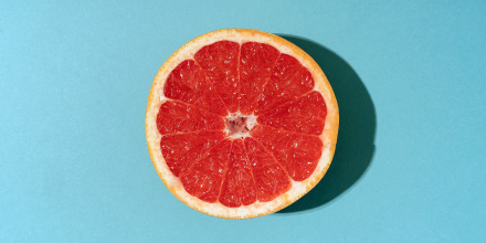 Grapefruit against vibrant blue background.