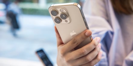 A customer holds the new Apple iPhone 16 Pro in her hand
