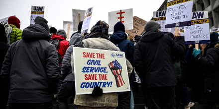 People rally at Health and Human Services headquarters to protest the polices of President Donald Trump and Elon Musk