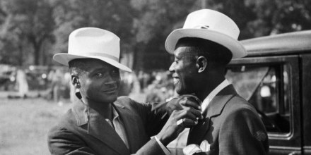 An African-American man adjusting his friend's tie in Kansas City, circa 1940