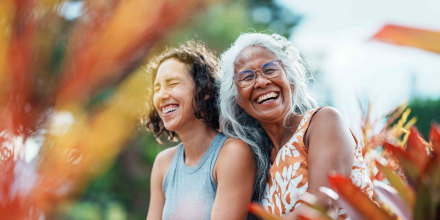 Pacific Islander woman and Eurasian adult daughter spending time together outdoors
