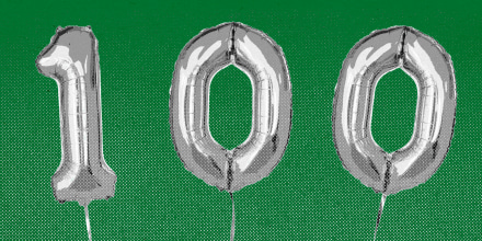 Balloons that spell the number 100, against a green background.