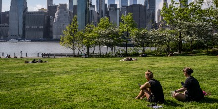 People sit in Brooklyn Bridge park