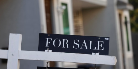 A "For Sale" sign outside a house in Houston. 