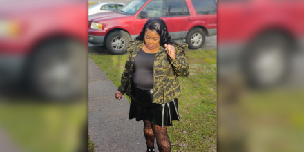 Valerie Elder Smiley standing in front of her car, which is also missing. 