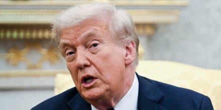 Donald Trump speaks while seated in the Oval Office