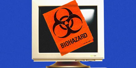 Photo illustration ofa biohazard sticker pasted on top of a vintage computer 