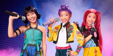 Three girls dressed up in Halloween costumes depicting characters from the girl group in KPop Demon Hunters