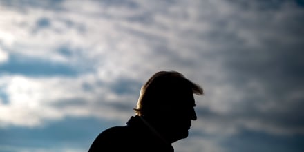 President Donald Trump against a cloudy sky.