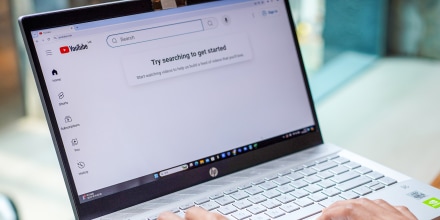 A woman browses Youtube website on her laptop.