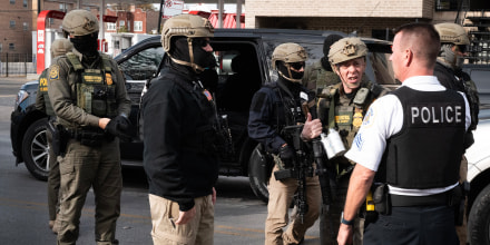 Border Patrol chief Greg Bovino speaks with a Chicago Police officer.