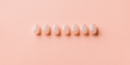 Row of cough drops against a soft orange background