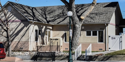 The exterior of Wellspring Health Access, a beige building