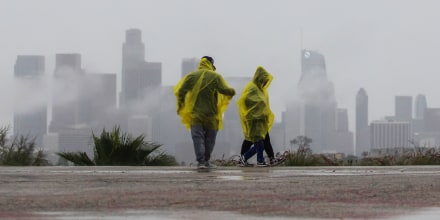 A family walks in the rain at Elysian Park on Dec. 24, 2025 in Los Angeles, California