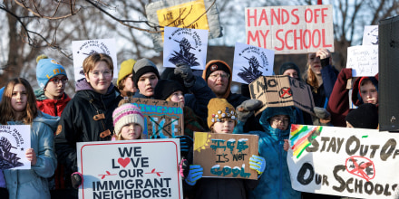 Minneapolis public school families, educators and students hold signs during a news conference at Lake Hiawatha Park in Minneapolis, on Friday, Jan. 9, 2026, demanding Immigration and Customs Enforcement be kept out of schools.