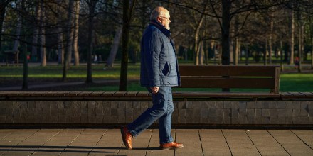 A senior man walking in the park