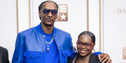 Snoop Dogg, left, places his arm around Cori Broadus' shoulder, right