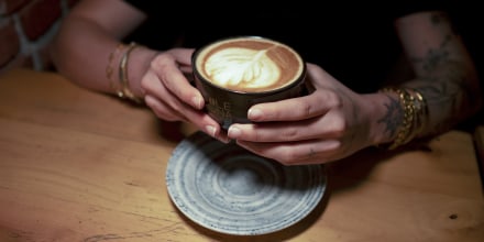 A person holding a cup of coffee