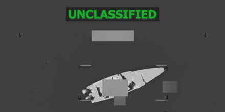 A black and white aerial view of a boat on the water, green text at the top reads "unclassified"