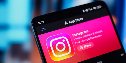 The Instagram logo appears on a smartphone screen in the Apple app store