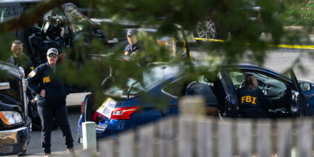 FBI officials examine a vehicle of suspected January 6, 2021 pipe bomber.