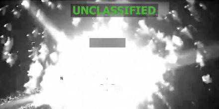 A grainy black-and-white surveillance image of an explosion that says UNCLASSIFIED across the top. 