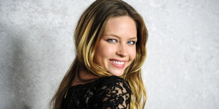 Daveigh Chase smiles while looking over her shoulder, posing for a portrait