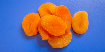 Dried apricots on a blue background