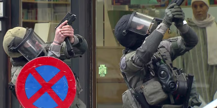 Image: Armed Belgian police secure the area upon their arrival in Molenbeek, near Brussels