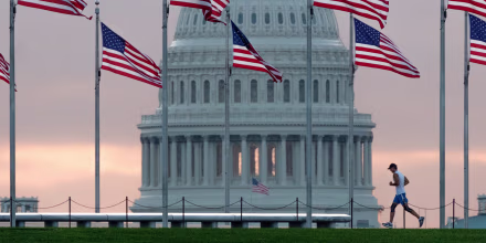Image: An early morning runner crosses in front of the U.S. Capitol