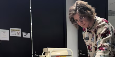 Archivist Mary Finch opens one of the 118 Bush family scrapbooks at the George H.W. Bush Presidential Library and Museum in College Station, Texas.
