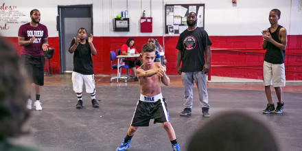 Khali Sweeney, center right, watches a student train at the Downtown Boxing Gym in Detroit.