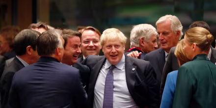 Image: British Prime Minister Boris Johnson, center, is greeted by Luxembourg's Prime Minister Xavier Bettel, center left, during a round table meeting at an EU summit in Brussels