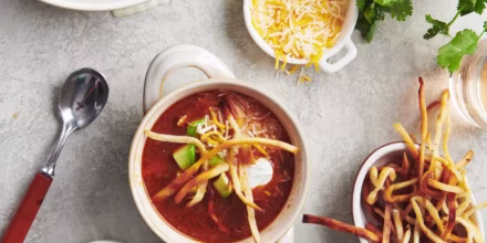 This soup is scented with chili, cumin and coriander, and topped with all kinds of deliciousness, like avocado and tortilla crisps.
