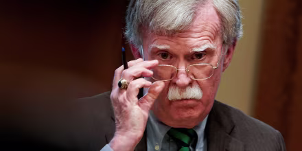 Image: National Security Advisor John Bolton adjusts his glasses as U.S. President Donald Trump speaks while meeting with NATO Secretary General Jens Stoltenberg in the Oval Office