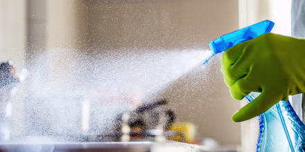 Spraying Cleaning Product on the Kitchen Counter